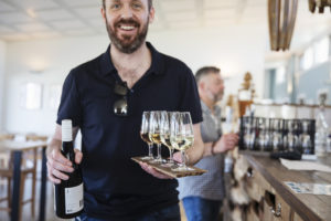 Customer with tasting flight in the Four Winds Vineyard Cellar Door