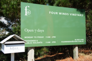 Green entry sign to Four Winds Vineyard